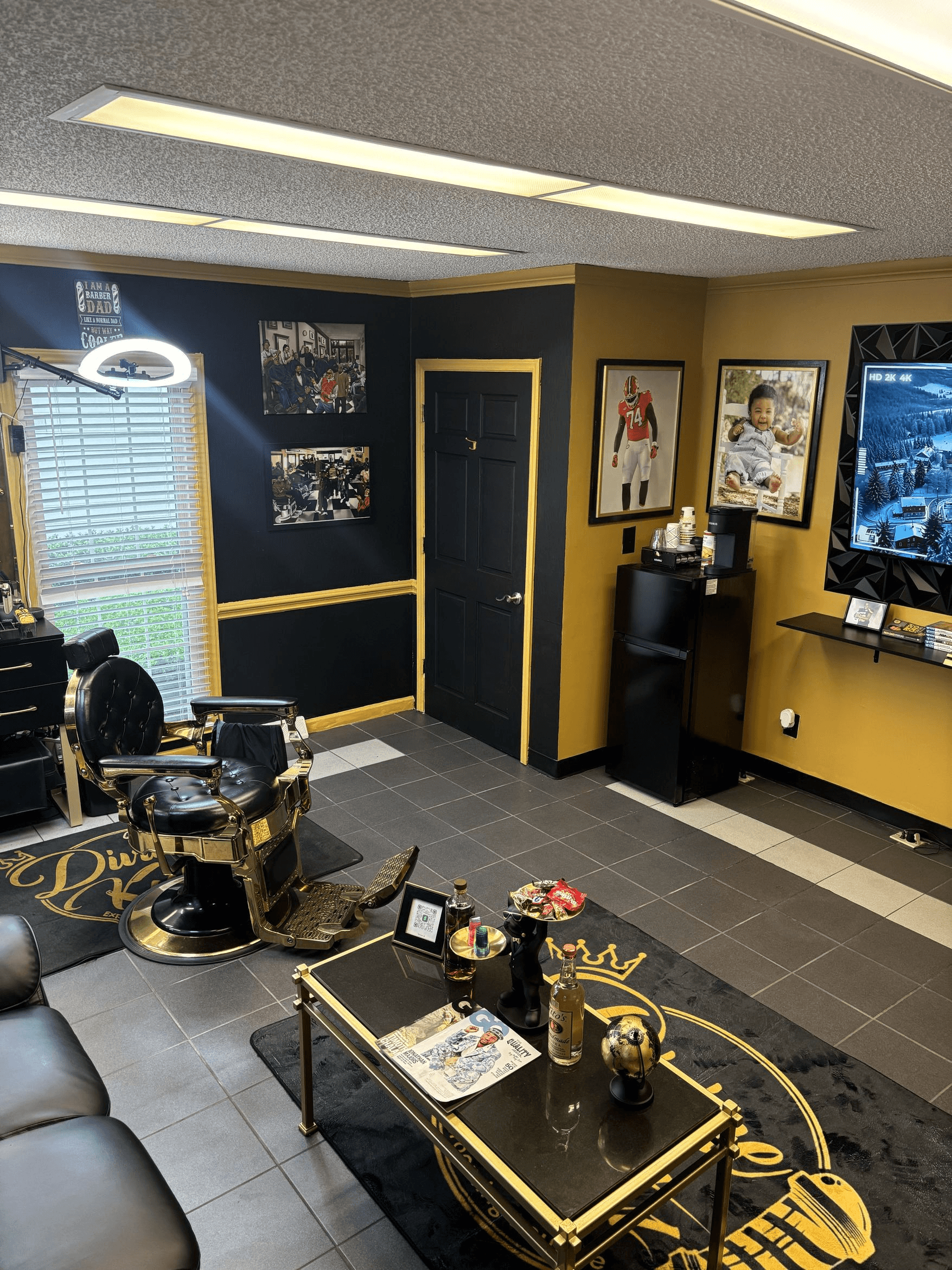 Divine Kutz premium barbershop interior — gold barber chairs and lounge area